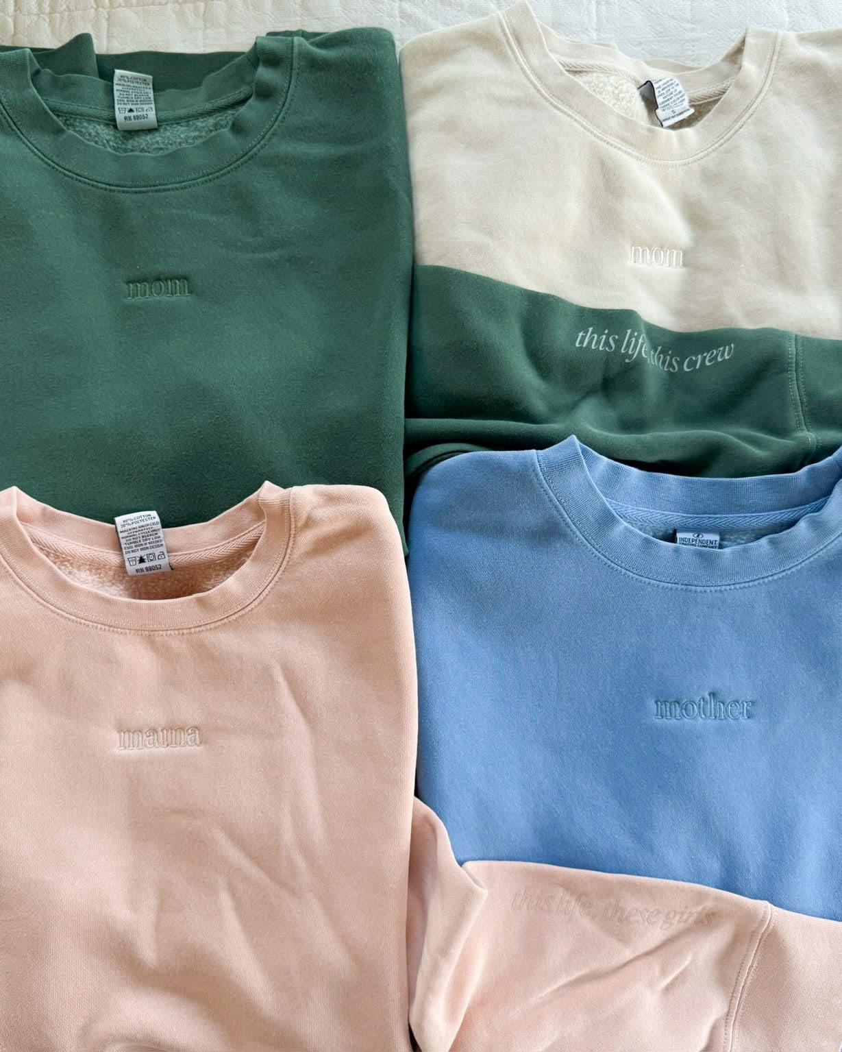 Adult crewneck in alpine, cream, blush, and light blue with mama, mom, or mother embroidered on the chest, seen on flat lay - Little Mama Shirt Shop