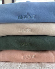Adult crewneck in alpine, cream, blush, and light blue with mama, mom, or mother embroidered on the chest, seen on flat lay - Little Mama Shirt Shop
