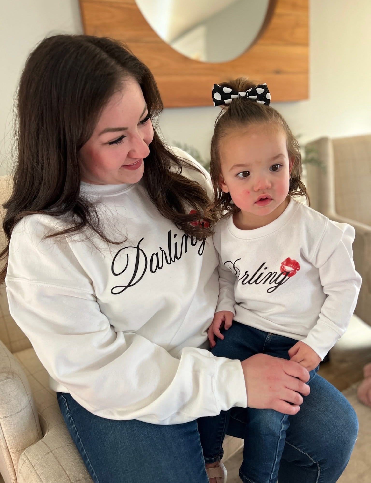 Adult and child white sweaters with "Darling" script and lipstick kiss design, shown on models  – Little Mama Shirt Shop
