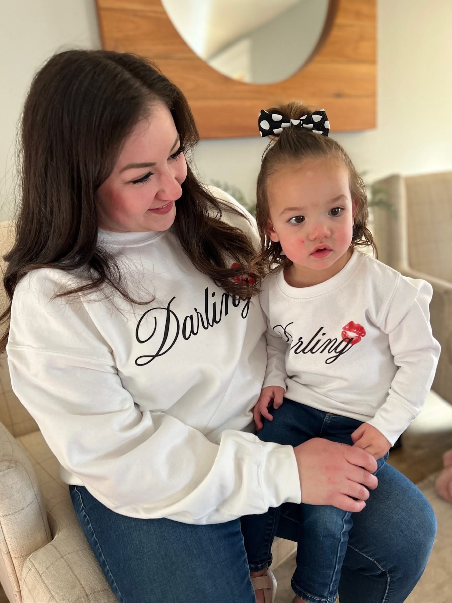 Adult and child white sweaters with "Darling" script and lipstick kiss design, shown on models  – Little Mama Shirt Shop