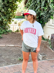 White adult comfort colors tee with red 'mother' puff print across the front, seen on model - Little Mama Shirt Shop