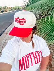 White adult comfort colors tee with red 'mother' puff print across the front also featuring 'these are the good old days' hat, seen on model - Little Mama Shirt Shop