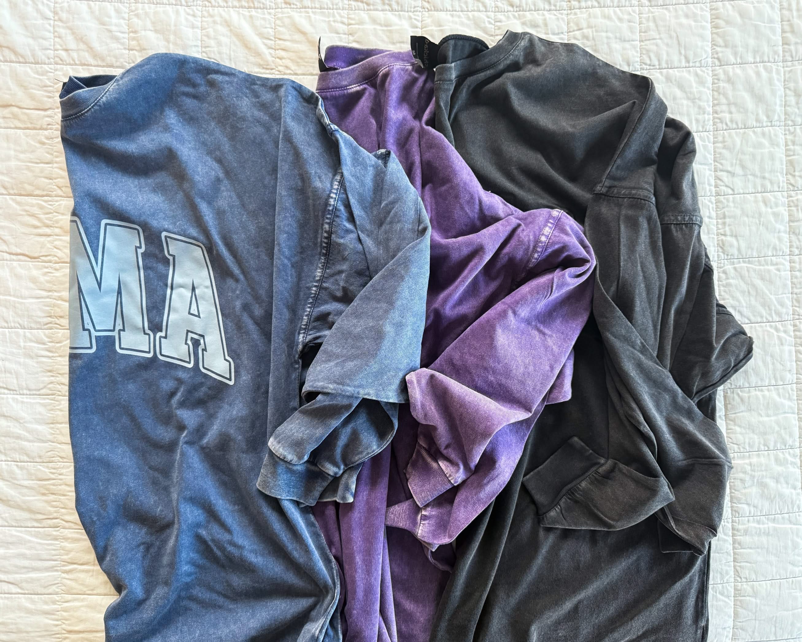 Oversized Big Tee with “MAMA” graphic in purple, washed denim, and black on flatlay - Little Mama Shirt Shop