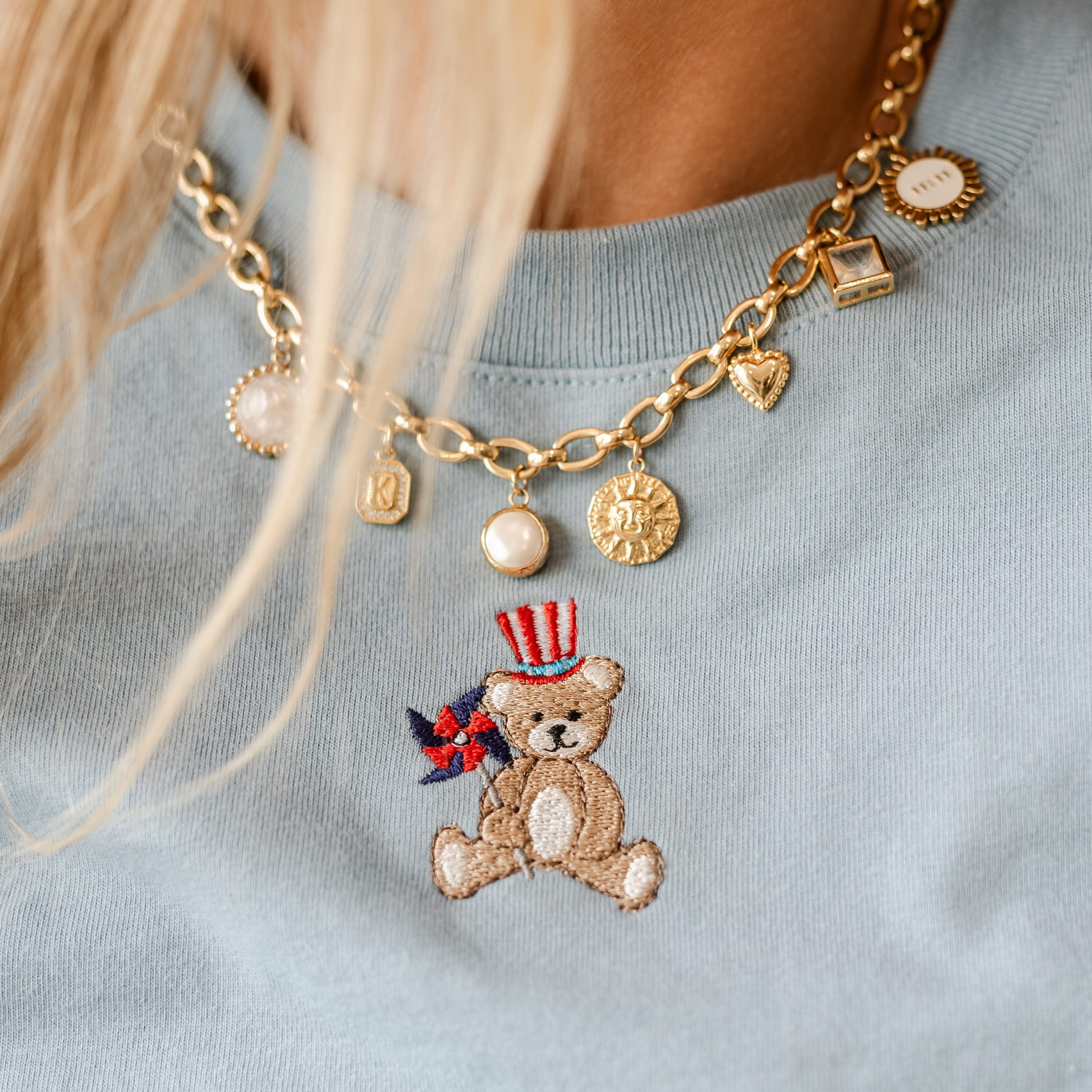 Embroidered Women's Heavyweight Tee - Teddy with Patriotic Top Hat and Pinwheel (center) Little Mama Shirt Shop