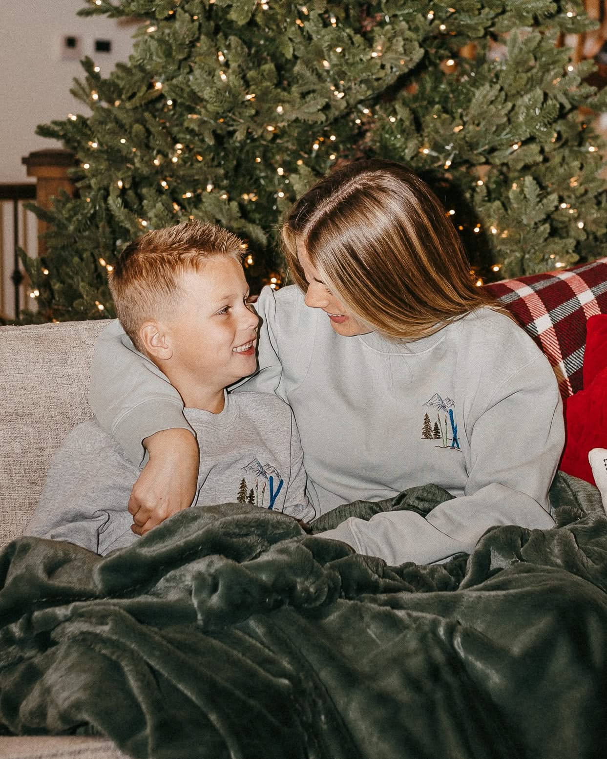 Child and adult sweater in gray with embroidered ski pattern, shown on model – Little Mama Shirt Shop