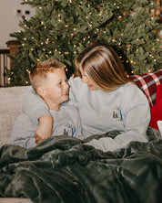 Child and adult sweater in gray with embroidered ski pattern, shown on model – Little Mama Shirt Shop