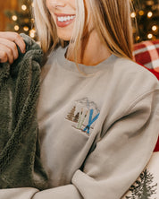 Adult sweater in sage with embroidered ski pattern, shown on model – Little Mama Shirt Shop