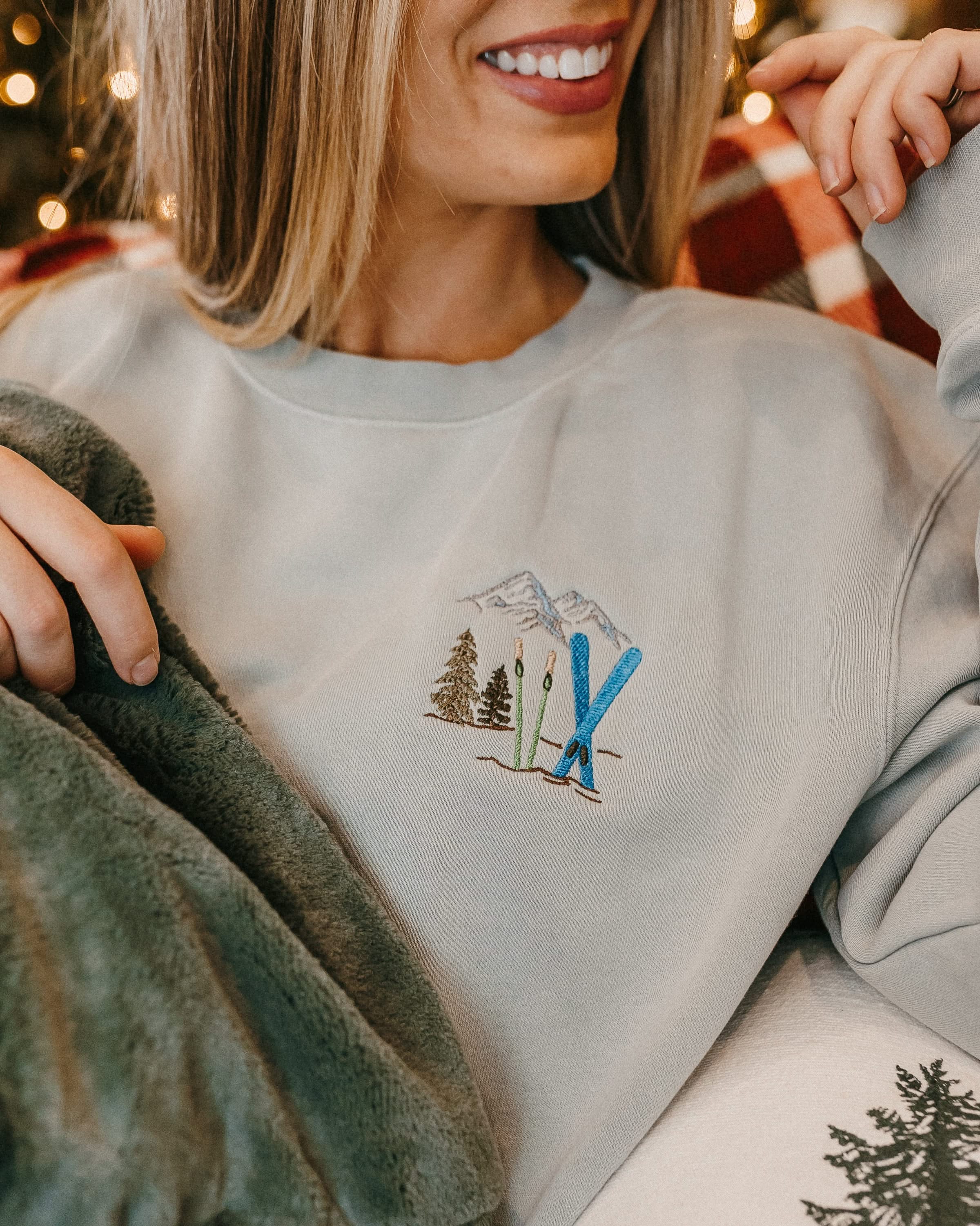 Adult sweater in sage with embroidered ski pattern, shown on model – Little Mama Shirt Shop