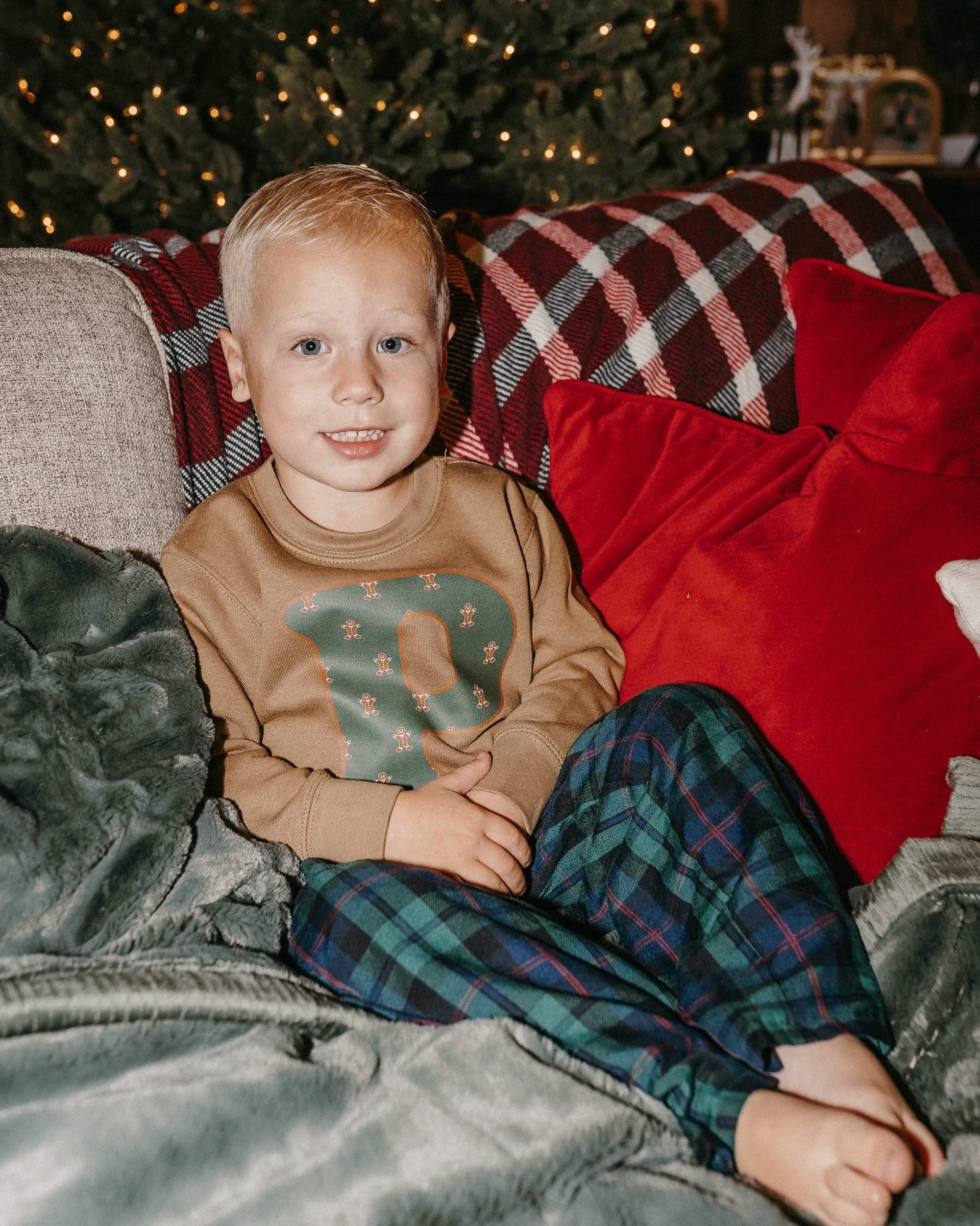 Child long sleeve in coyote brown with Christmas patterned gingerbread men initial P on front, shown on model – Little Mama Shirt Shop