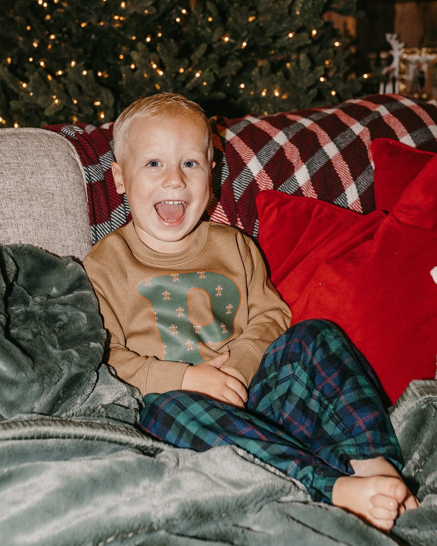 Child long sleeve in coyote brown with Christmas patterned gingerbread men initial P on front, shown on model – Little Mama Shirt Shop