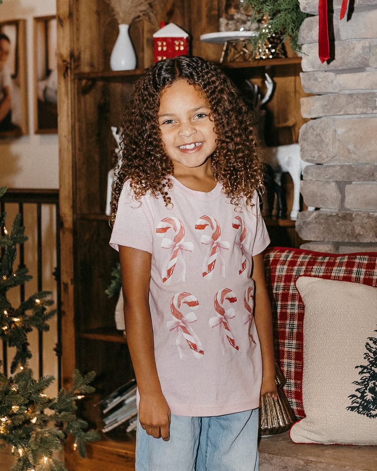 Child tee in ballerina pink with 6 candy canes on chest, shown on model – Little Mama Shirt Shop