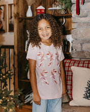 Child tee in ballerina pink with 6 candy canes on chest, shown on model – Little Mama Shirt Shop