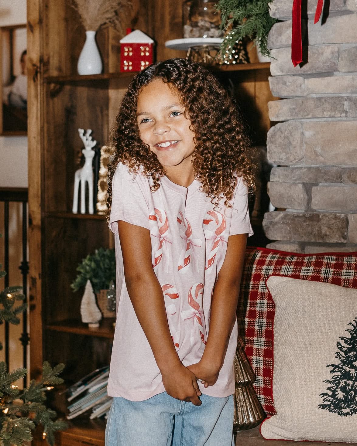 Child tee in ballerina pink with 6 candy canes on chest, shown on model – Little Mama Shirt Shop