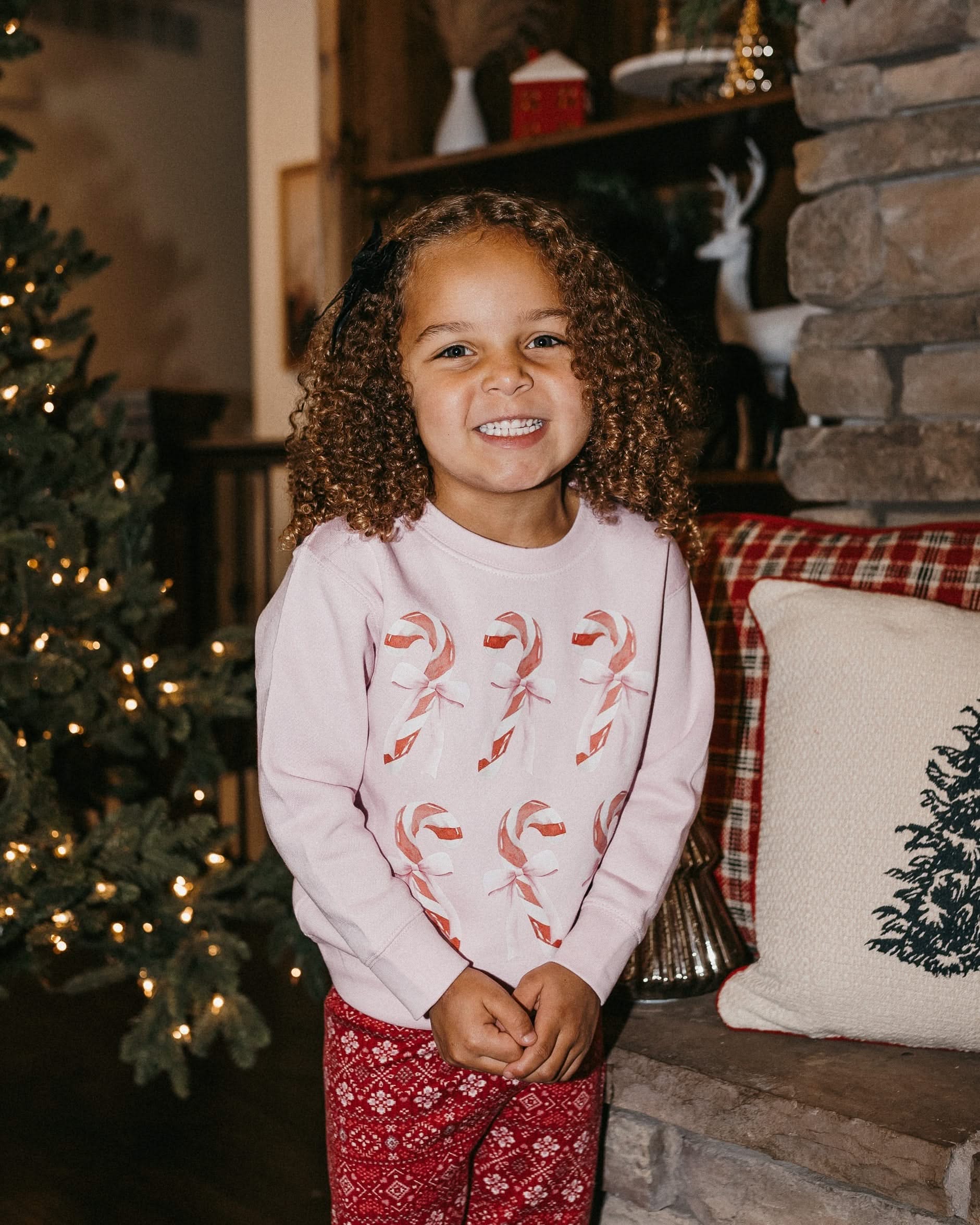 Child Sweater in pink with 6 candy canes on chest, shown on model – Little Mama Shirt Shop