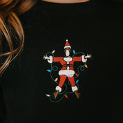 Child sweater in black with Santa wrapped in lights embroidery on front, shown on model – Little Mama Shirt Shop
