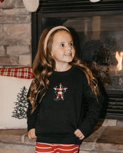 Child sweater in black with Santa wrapped in lights embroidery on front, shown on model – Little Mama Shirt Shop