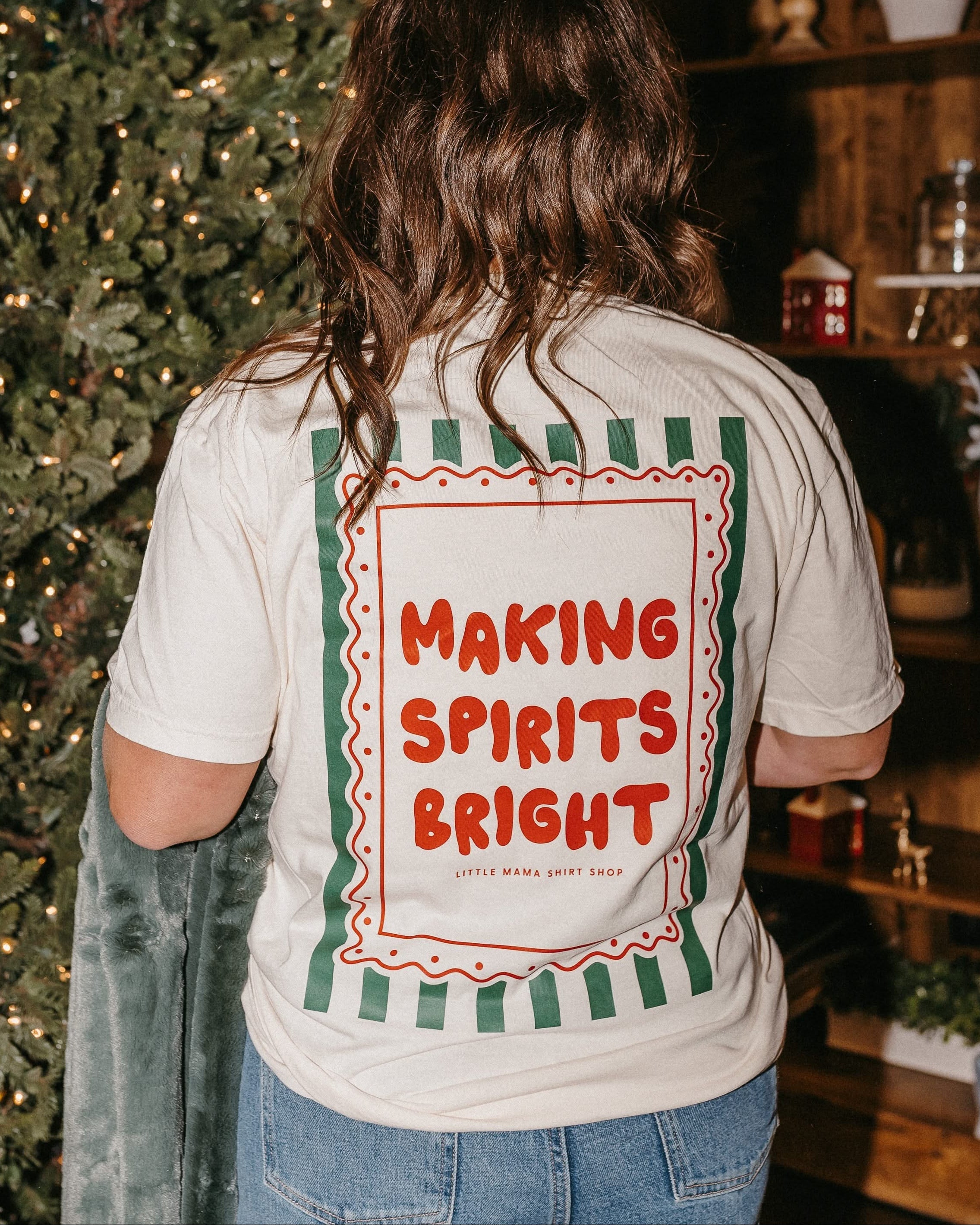 Adult ivory comfort colors tee with &#39;making spirits bright&#39; graphic on back, shown on model – Little Mama Shirt Shop