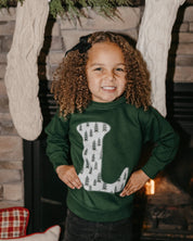 Child long sleeve in forest with Christmas patterned trees initial L on front, shown on model – Little Mama Shirt Shop