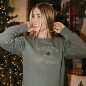 Adult sweater in alpine with 'Believe in the magic, feel the wonder' designs on front, shown on model – Little Mama Shirt Shop