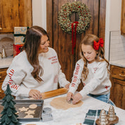 Adult and child sweater in natural with Christian Christmas graphics on the front, shown on model – Little Mama Shirt Shop