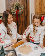 Adult and child sweater in natural with Christian Christmas graphics on the front, shown on model – Little Mama Shirt Shop