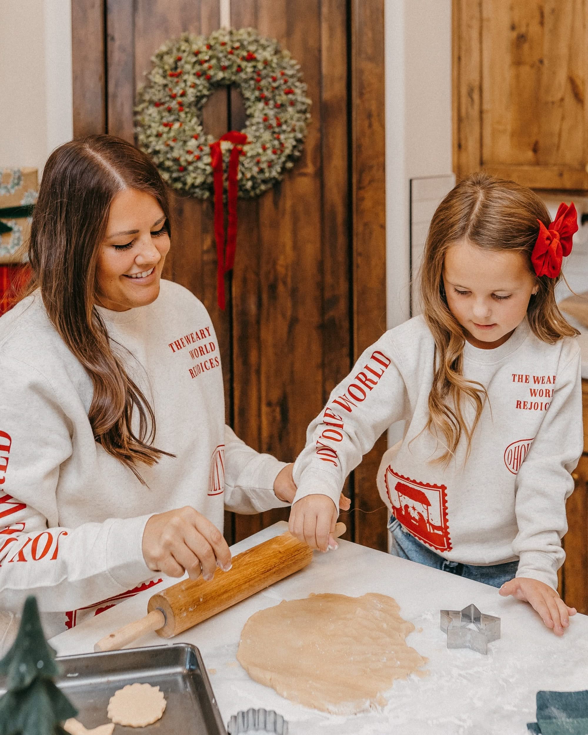 Adult and child sweater in natural with Christian Christmas graphics on the front, shown on model – Little Mama Shirt Shop