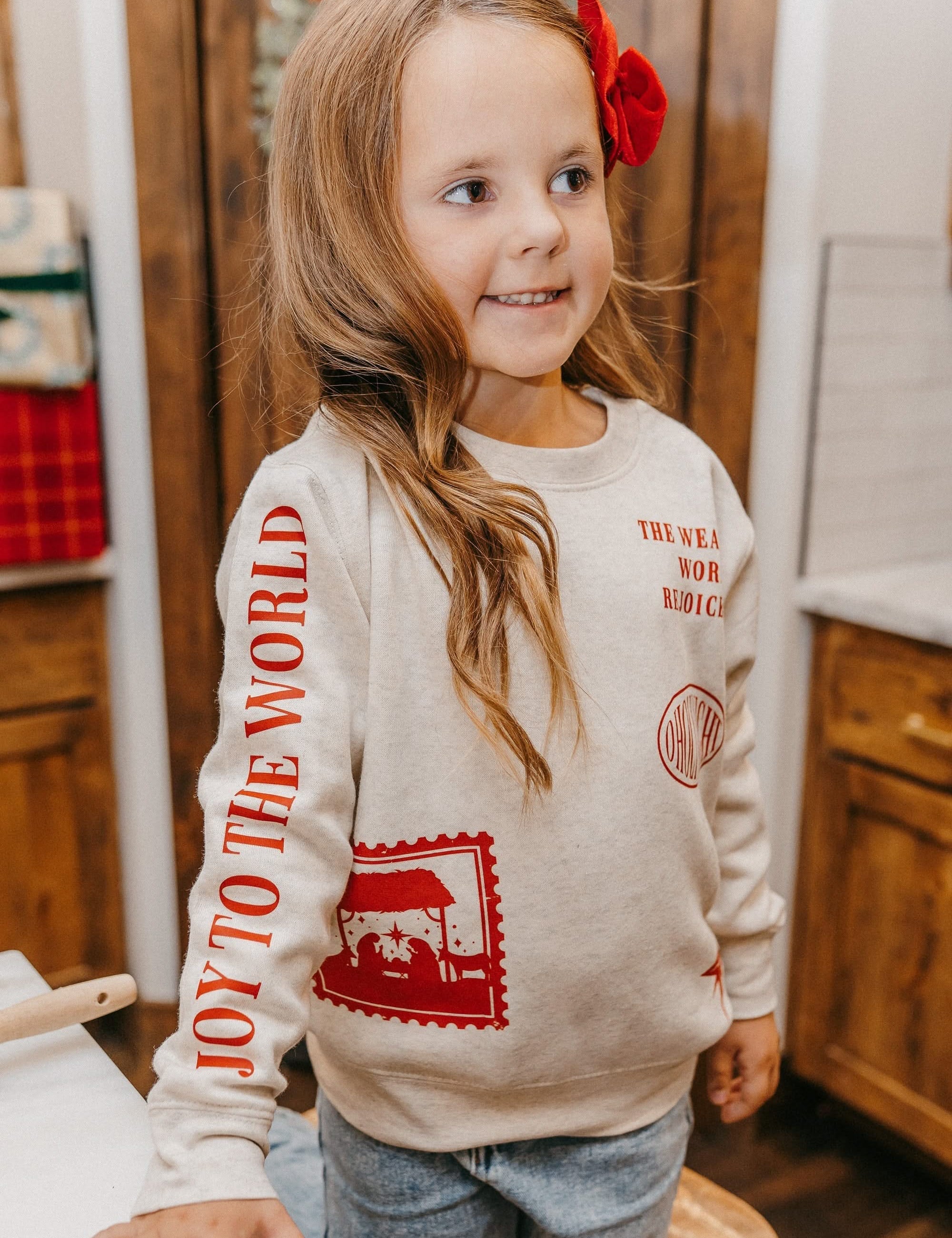 Child sweater in natural with Christian Christmas graphics on the front, shown on model – Little Mama Shirt Shop