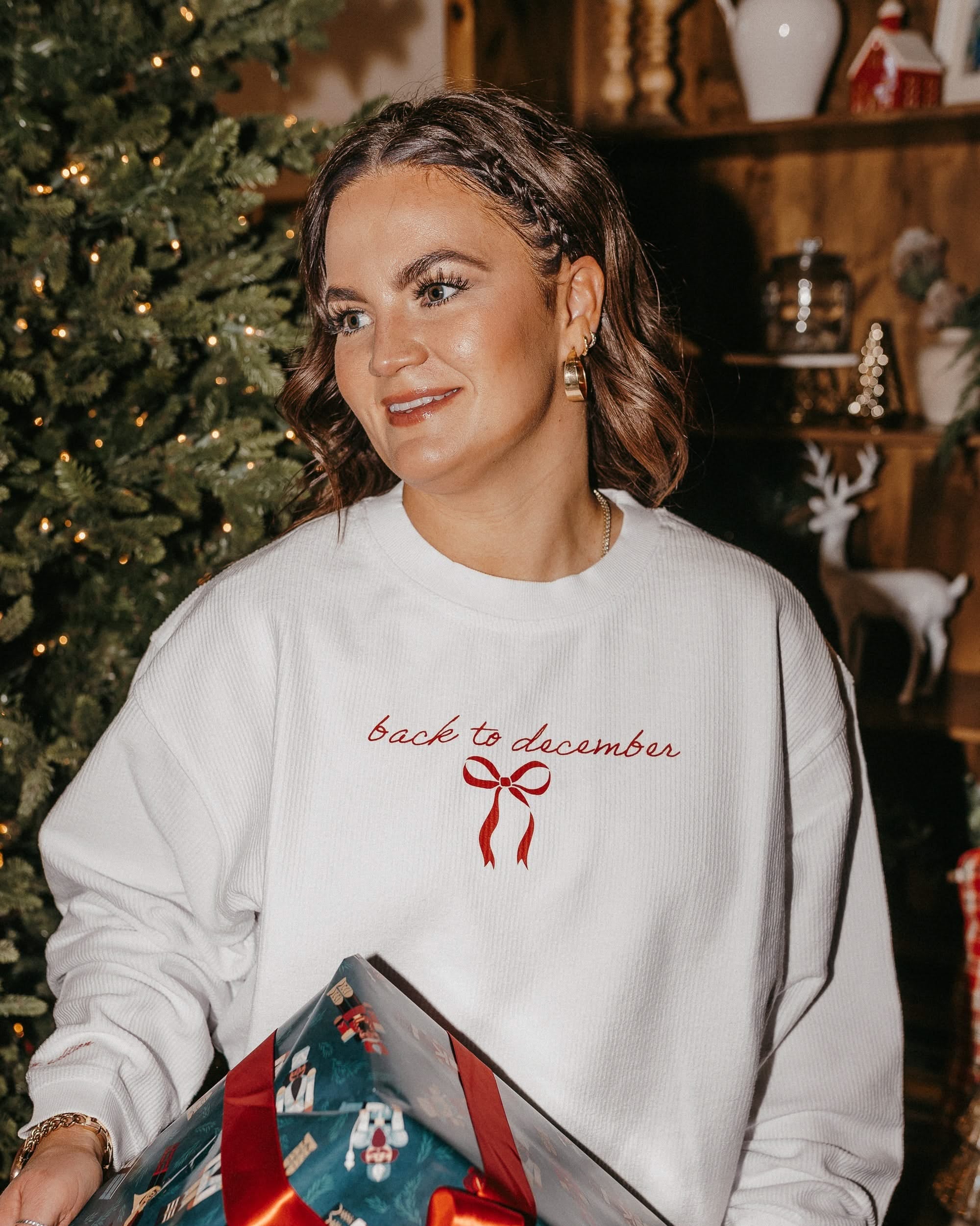 Adult sweater in white with 'back to December' and bow on chest, shown on model – Little Mama Shirt Shop