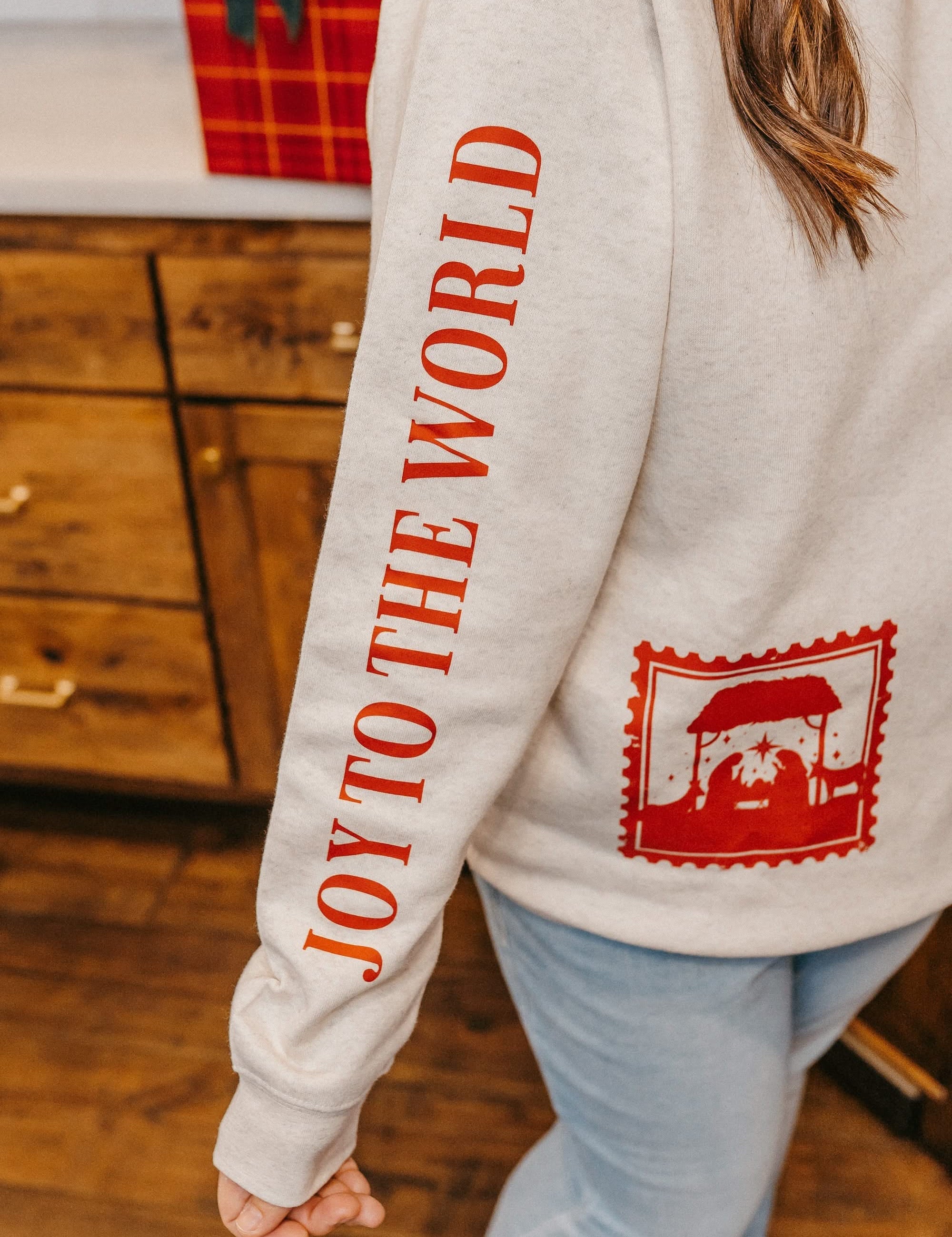 Adult sweater in natural with Christian Christmas graphics on the front, shown on model – Little Mama Shirt Shop