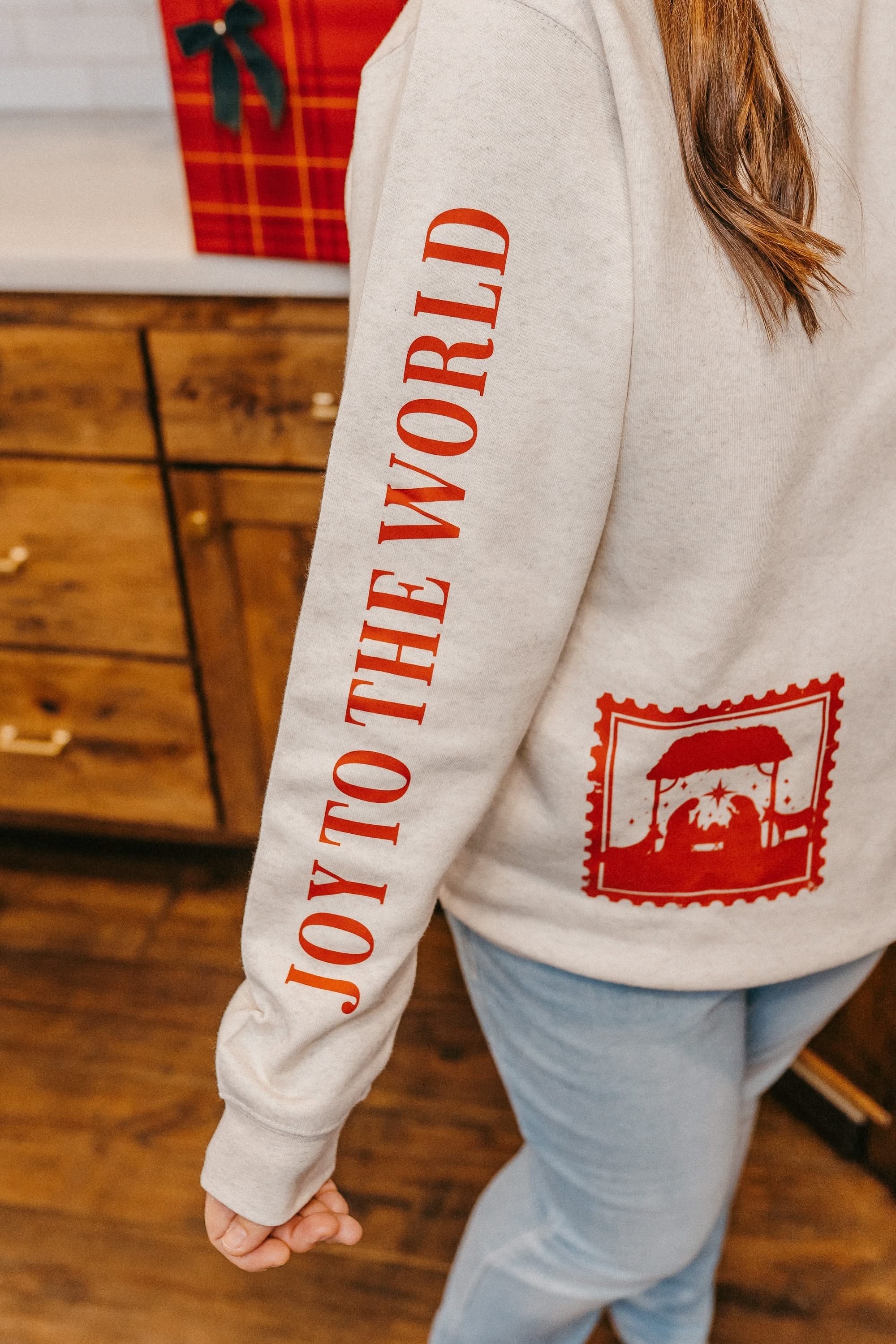 Adult sweater in natural with Christian Christmas graphics on the front, shown on model – Little Mama Shirt Shop