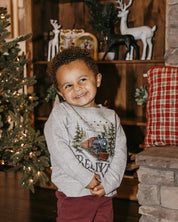 Child sweater in gray with winter train and 'Believe' on chest, shown on model – Little Mama Shirt Shop
