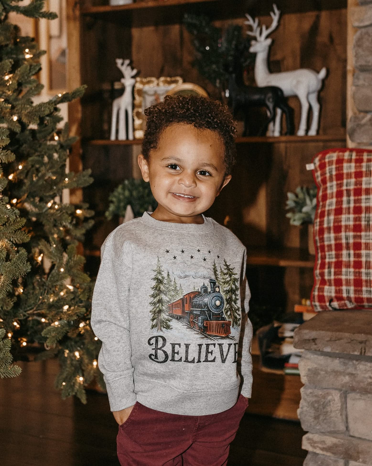Child sweater in gray with winter train and &#39;Believe&#39; on chest, shown on model – Little Mama Shirt Shop