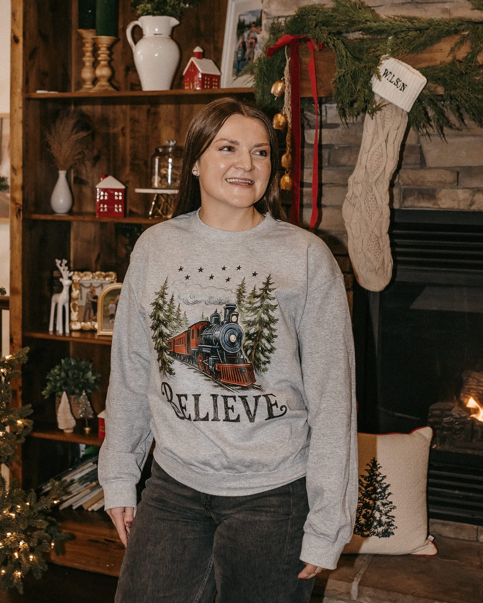 Adult Sweater in gray with winter train and 'Believe' on chest, shown on model – Little Mama Shirt Shop