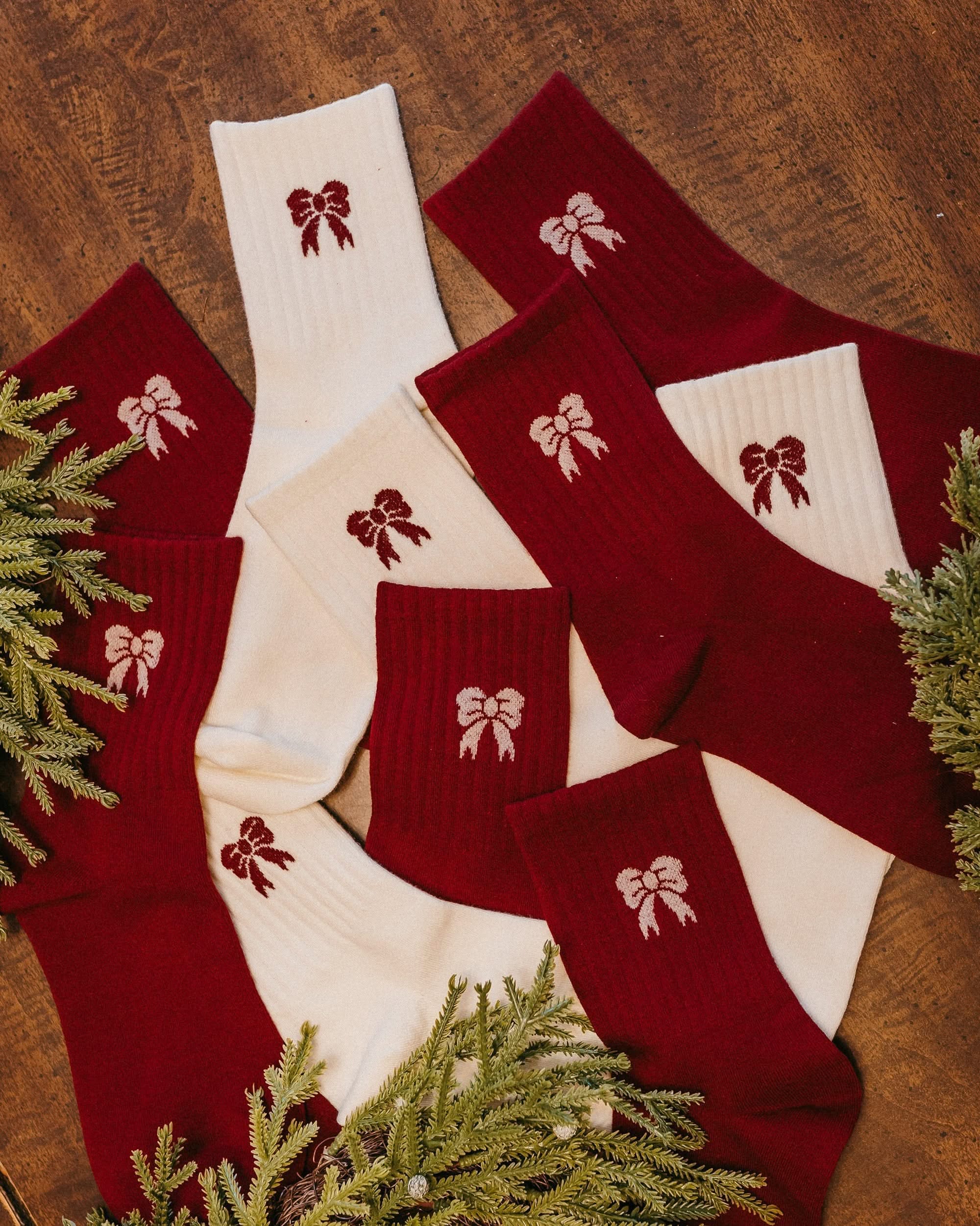Adult socks in red and white with bow pattern, shown on flat lay – Little Mama Shirt Shop