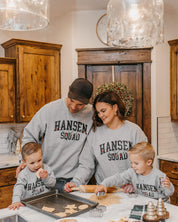 Adult and Kids basic fleece in gray with personalized last name printed on front with Christmas lights under, shown on models – Little Mama Shirt Shop