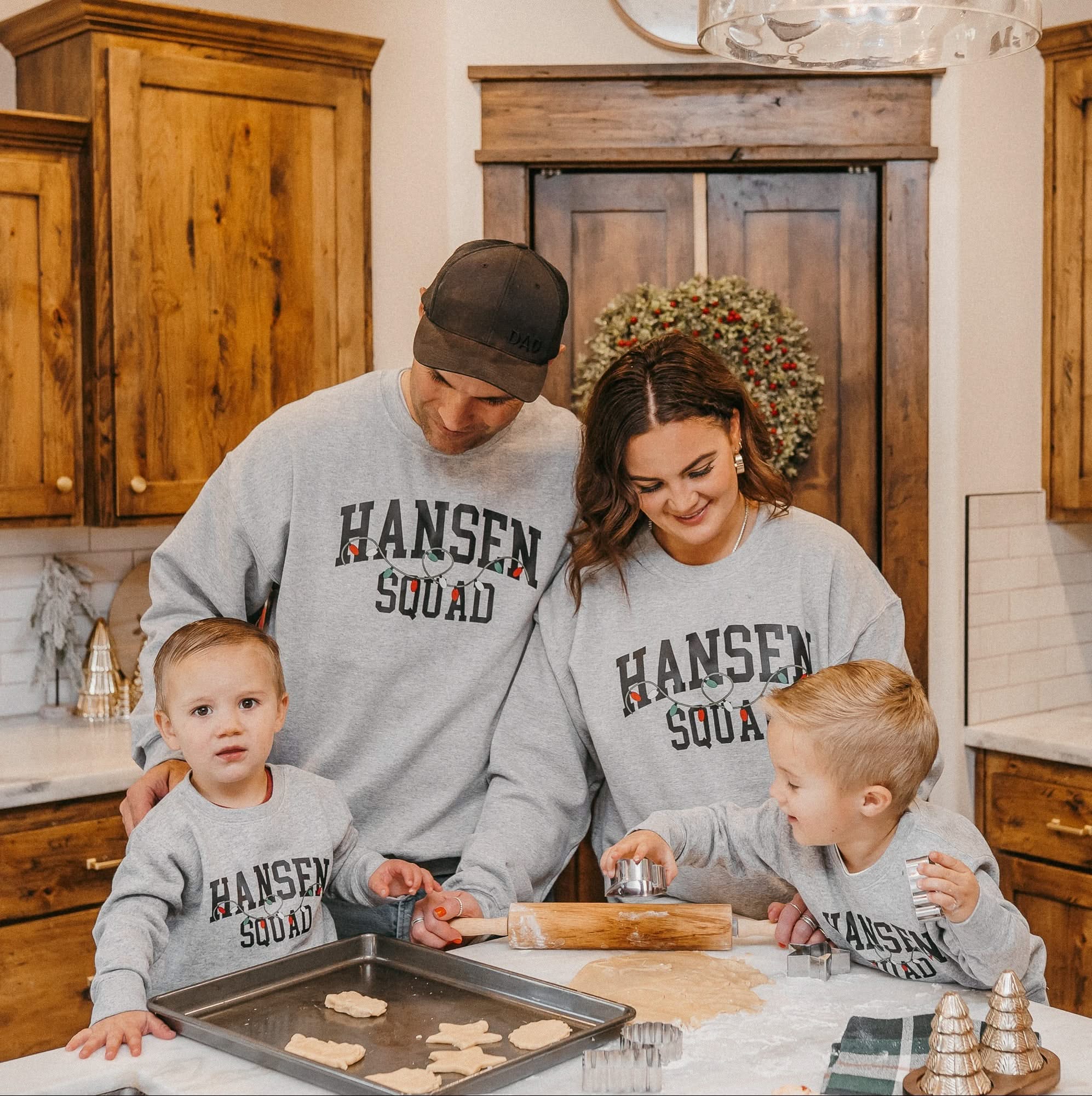 Adult and Kids basic fleece in gray with personalized last name printed on front with Christmas lights under, shown on models – Little Mama Shirt Shop