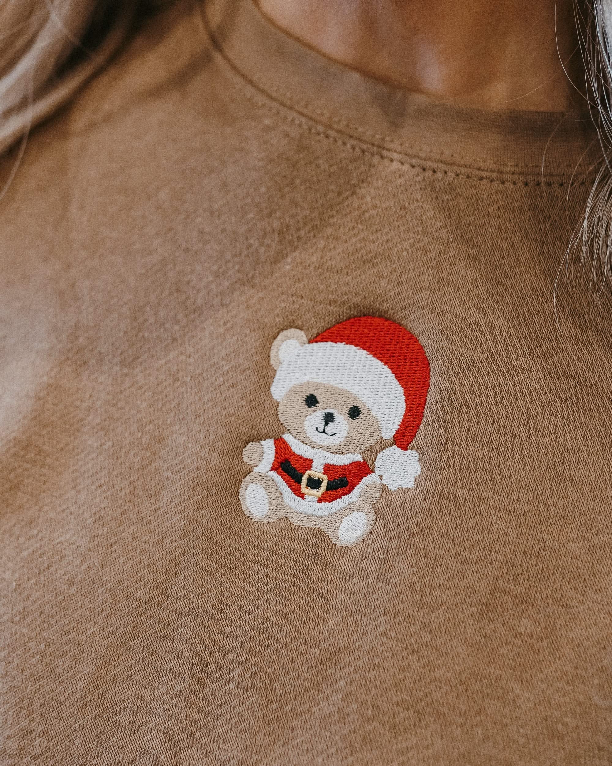 Adult sweater in coyote brown with embroidered Santa teddy bear on front, shown on model – Little Mama Shirt Shop