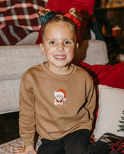 Kids sweater in coyote brown with embroidered Santa teddy bear on front, shown on model – Little Mama Shirt Shop