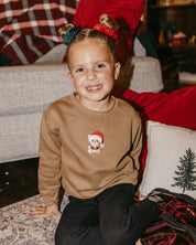 Kids sweater in coyote brown with embroidered Santa teddy bear on front, shown on model – Little Mama Shirt Shop