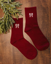 Adult socks in red and white with bow pattern, shown on flat lay – Little Mama Shirt Shop