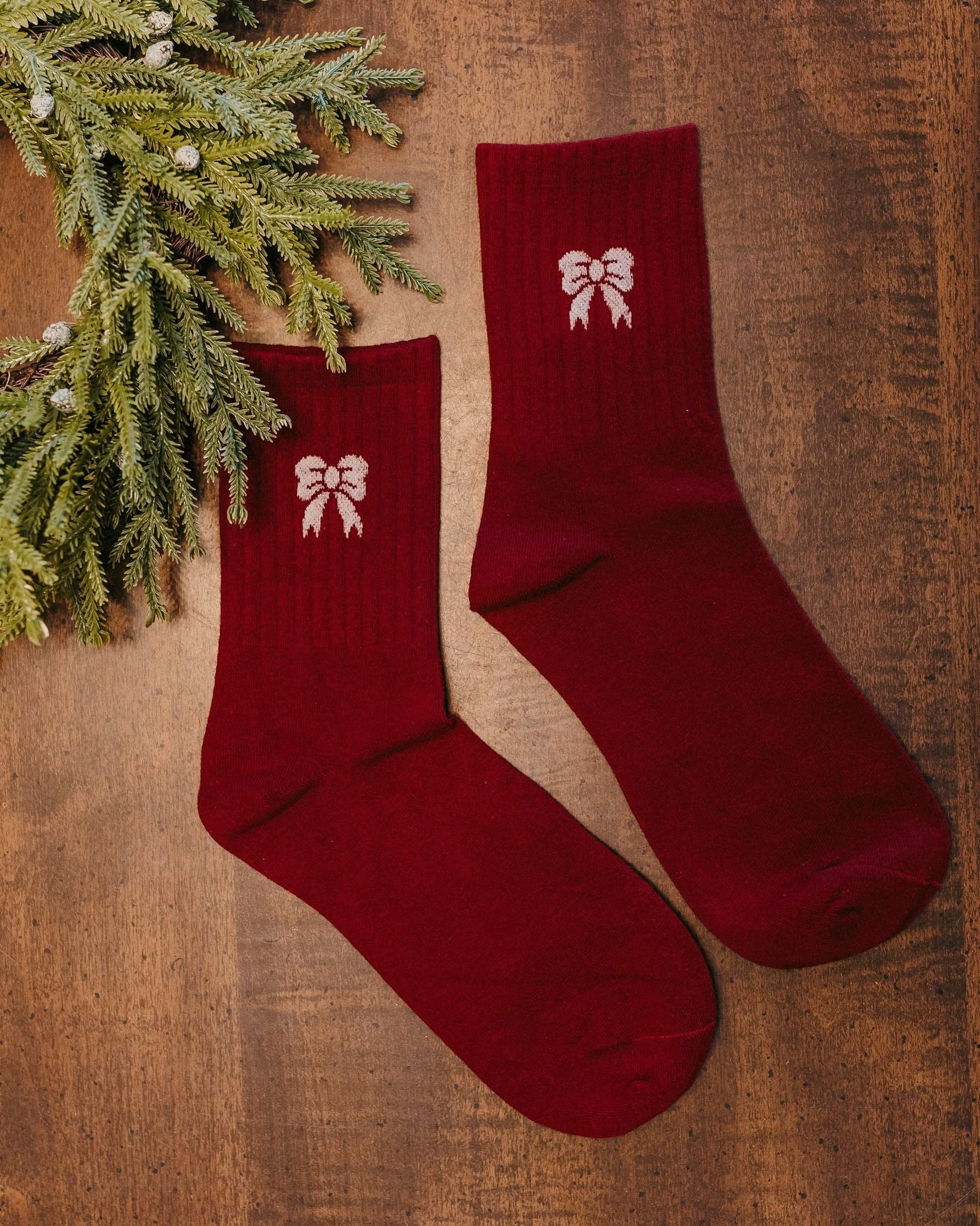 Adult socks in red and white with bow pattern, shown on flat lay – Little Mama Shirt Shop