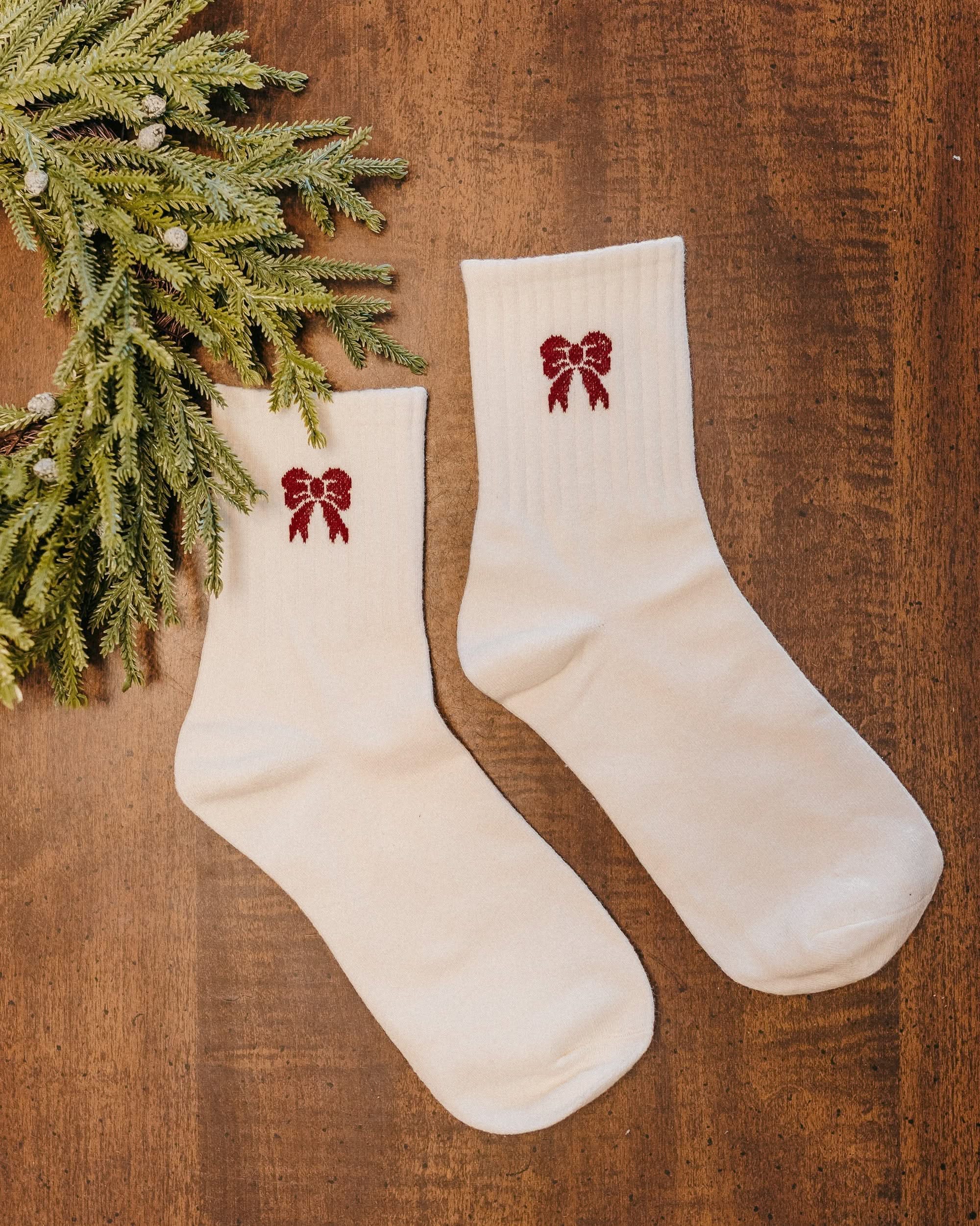 Adult socks in red and white with bow pattern, shown on flat lay – Little Mama Shirt Shop