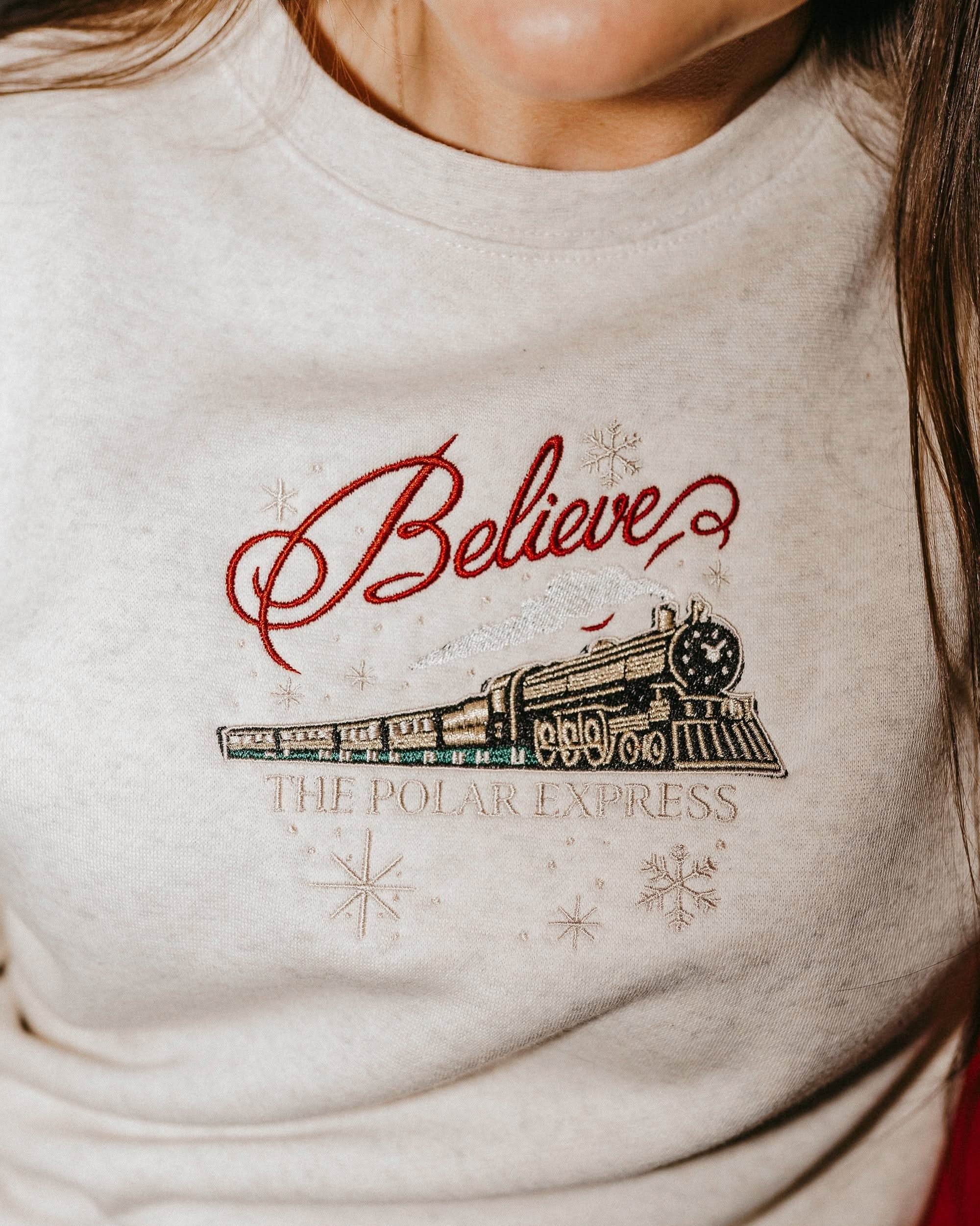 Adult sweater in heather with Believe Polar Express Train on front, shown on model – Little Mama Shirt Shop