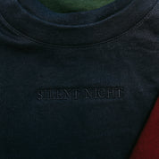 Adult tee in navy with Christmas message on front, shown on flat lay – Little Mama Shirt Shop