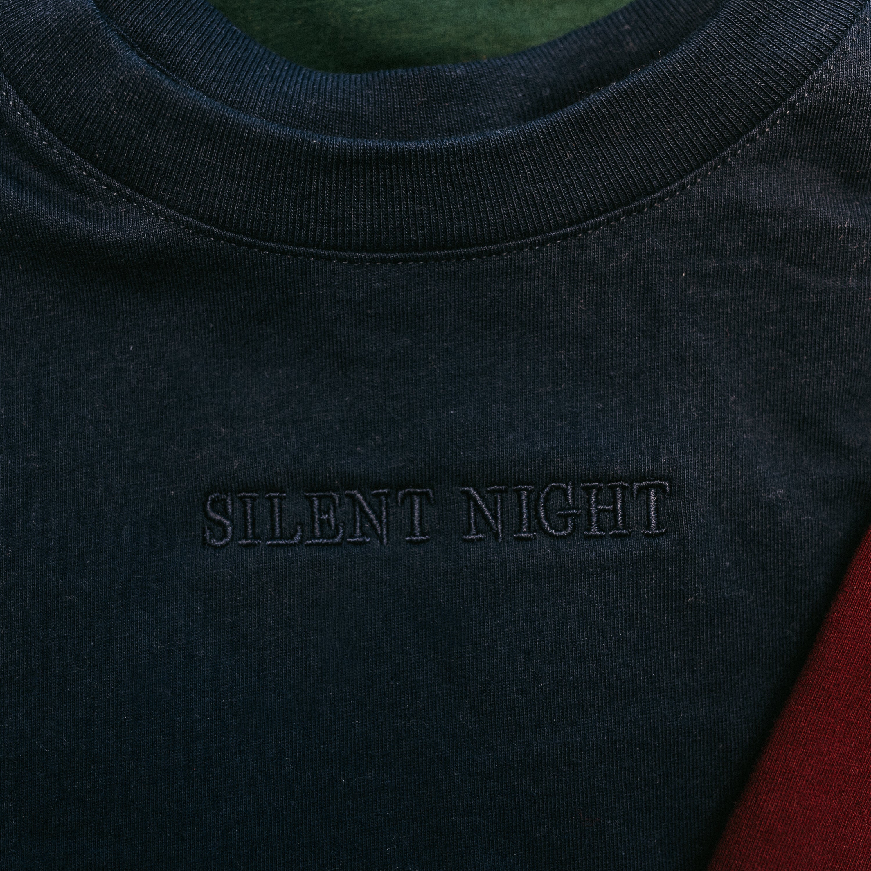 Adult tee in navy with Christmas message on front, shown on flat lay – Little Mama Shirt Shop