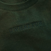 Adult tee in forest with Christmas message on front, shown on flat lay – Little Mama Shirt Shop