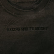 Adult tee in dark gray with Christmas message on front, shown on flat lay – Little Mama Shirt Shop