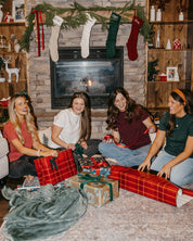 Adult tees in vintage red, vintage white, forest, and maroon with Christmas mini symbols on front, shown on model – Little Mama Shirt Shop