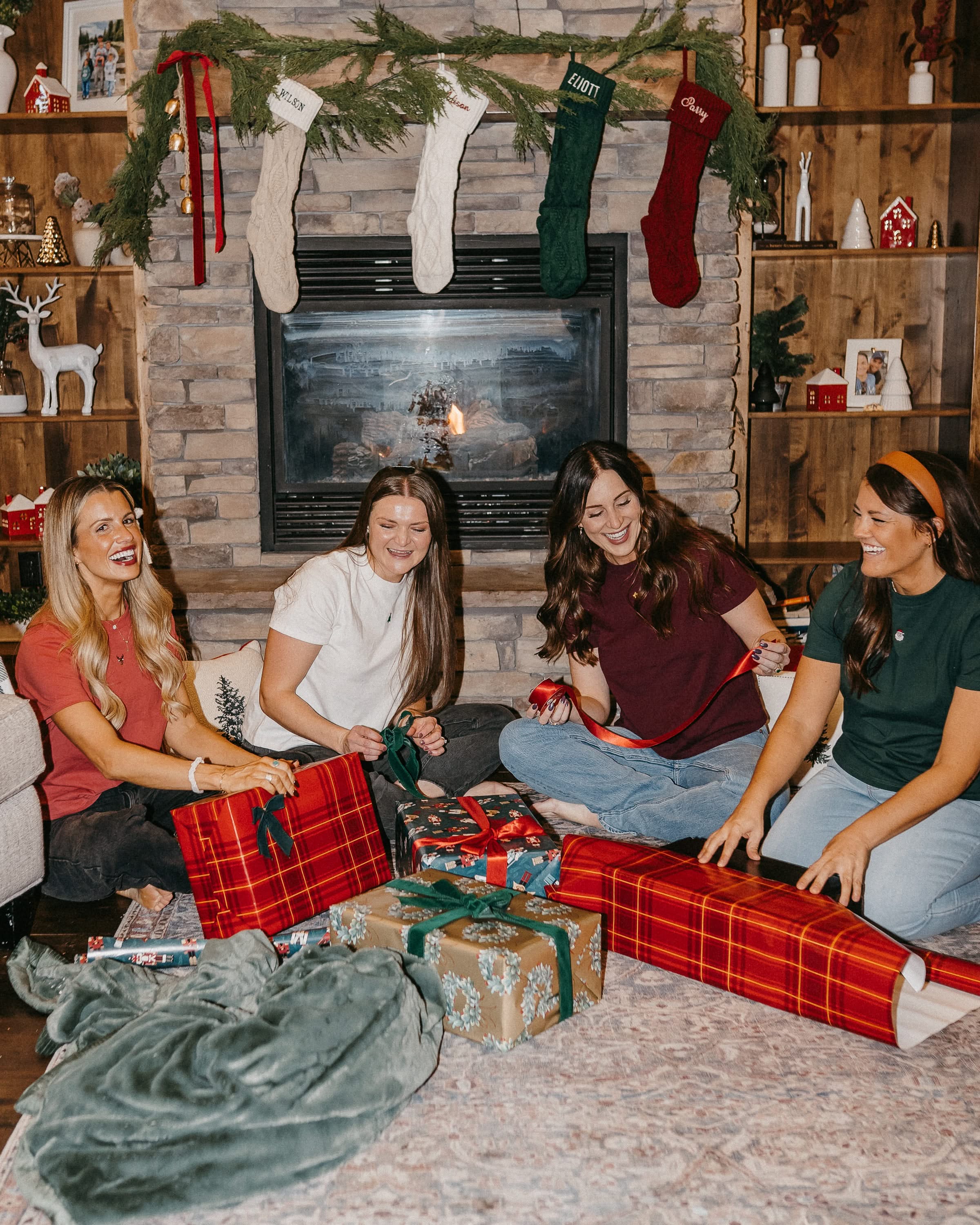 Adult tees in vintage red, vintage white, forest, and maroon with Christmas mini symbols on front, shown on model – Little Mama Shirt Shop