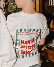 Child natural tee with 'making spirits bright' graphic, shown on model – Little Mama Shirt Shop
